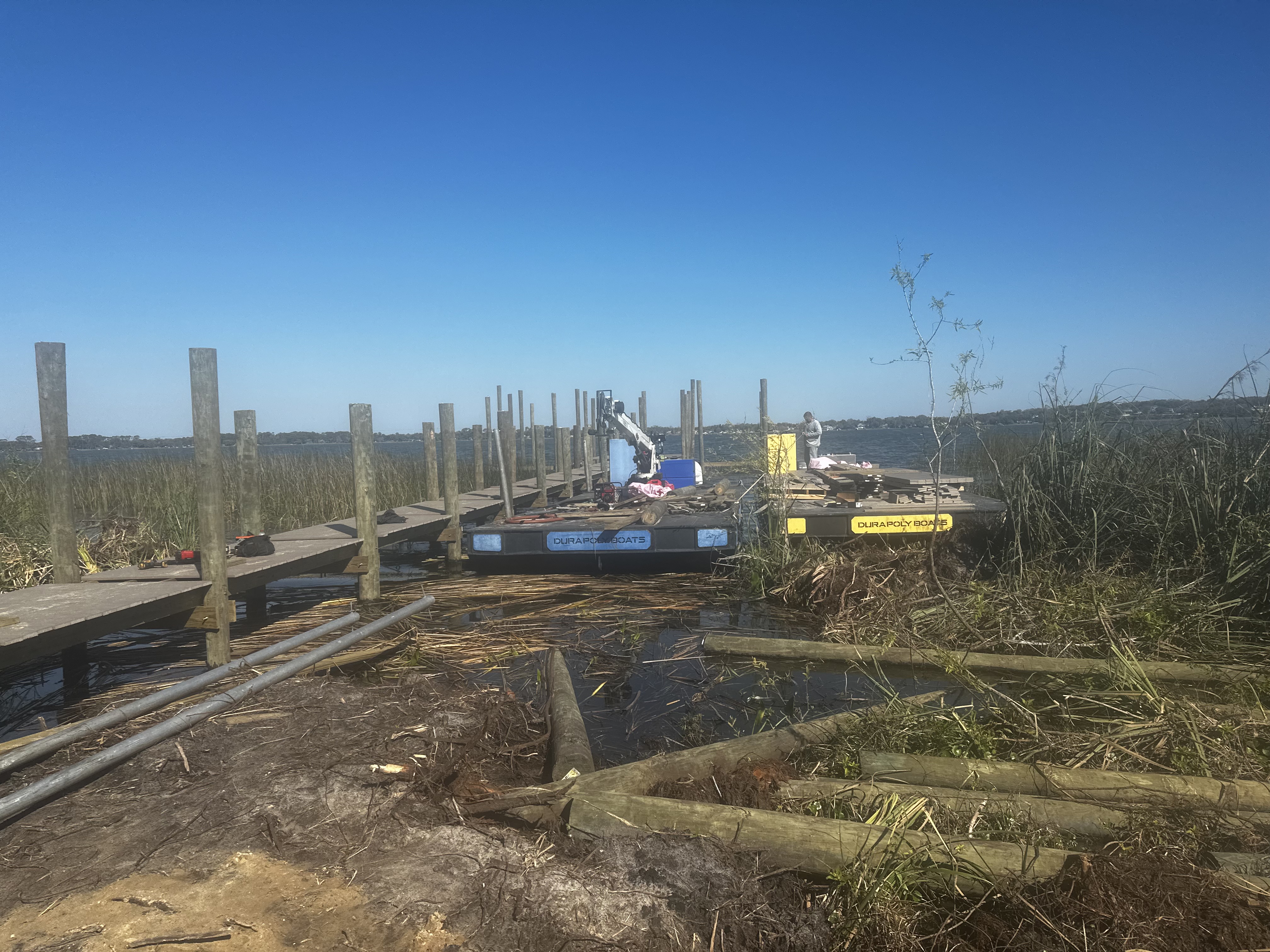 Shoreline Marine Solutions barges at work in a swampy area.